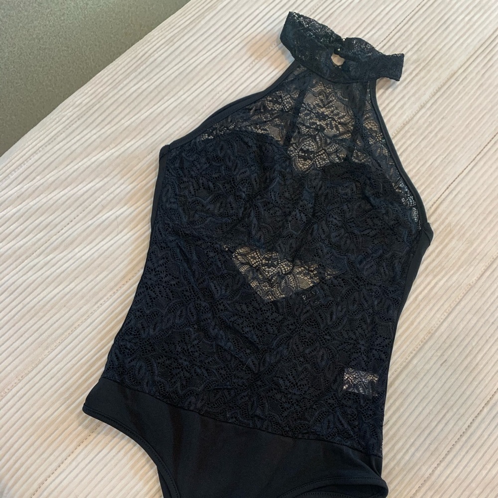 Foreground all lace body suit with open back.